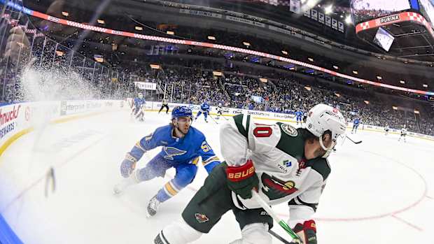 Mar 16, 2024; St. Louis, Missouri, USA; Minnesota Wild center Marcus Johansson (90) controls the puck as St. Louis Blues defenseman Matthew Kessel (51) defends during the first period at Enterprise Center.